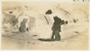 Image of Snow house and small boy with small sledge